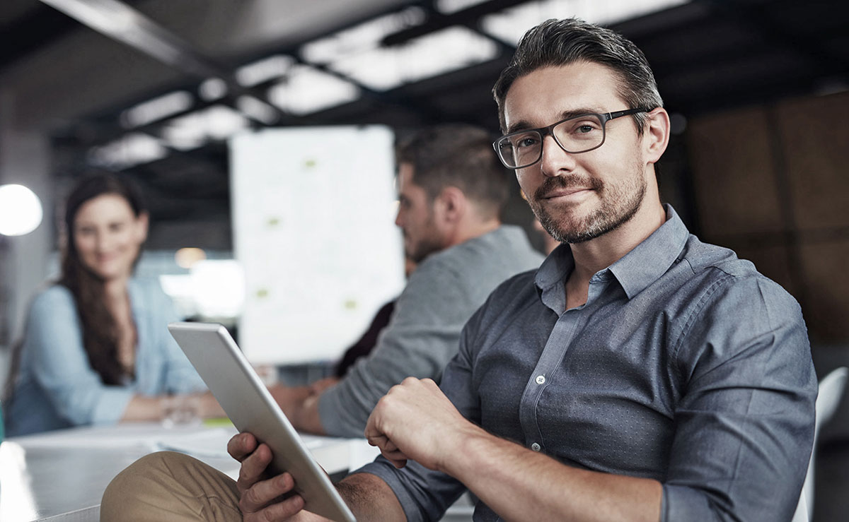Guy with an ipad looking into the camera