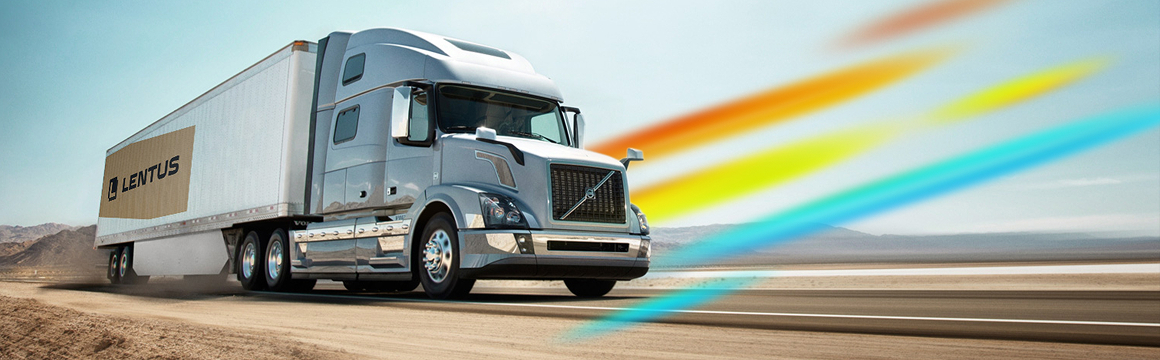 Semi truck driving down a desert road with the rainbmow logo over it